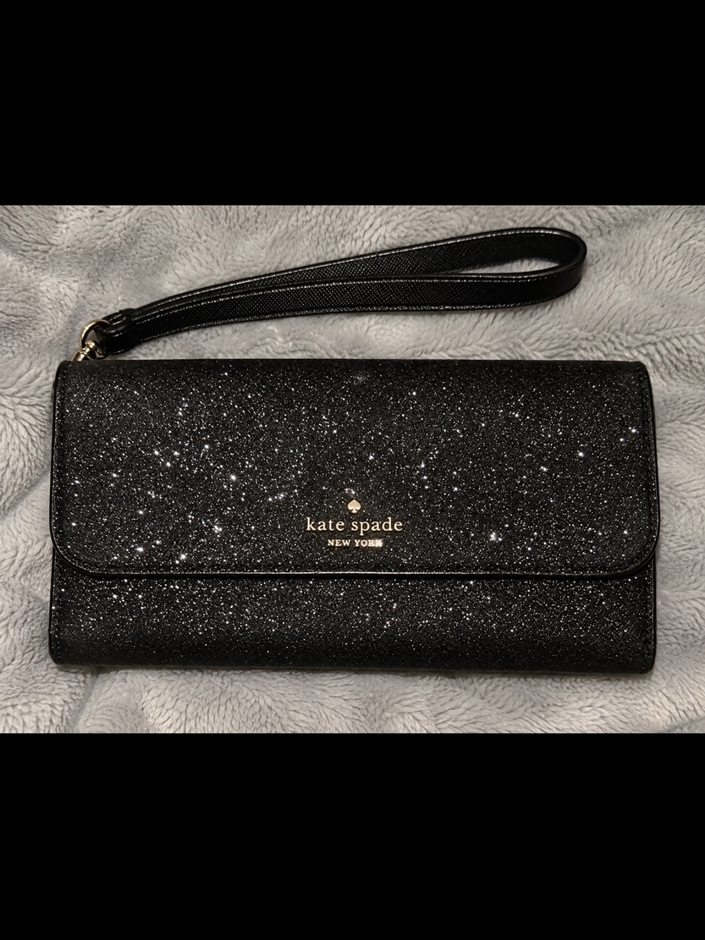 kate spade black glitter wristlet clutch with gold logo